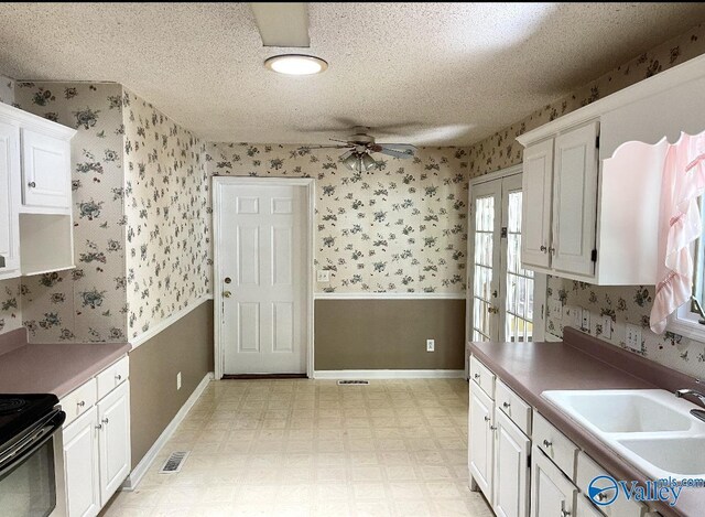 kitchen with white cabinetry, light tile patterned floors, a textured ceiling, and ceiling fan