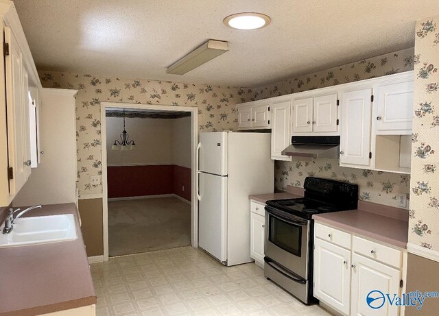 kitchen with white cabinets, white refrigerator, sink, light carpet, and stainless steel range with electric cooktop