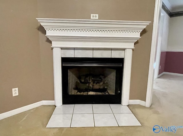 room details featuring baseboards and a tiled fireplace