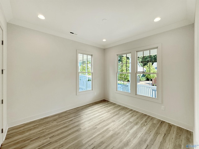 unfurnished room featuring ornamental molding and light hardwood / wood-style floors