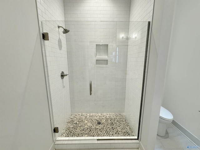 bathroom with toilet and an enclosed shower