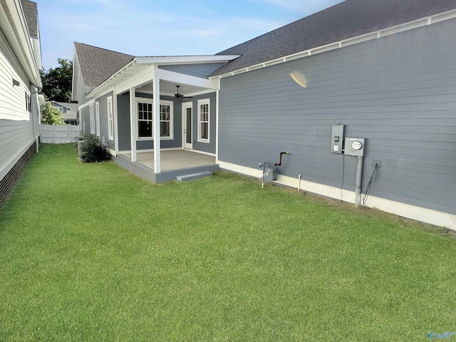 back of house featuring a patio area, ceiling fan, and a lawn