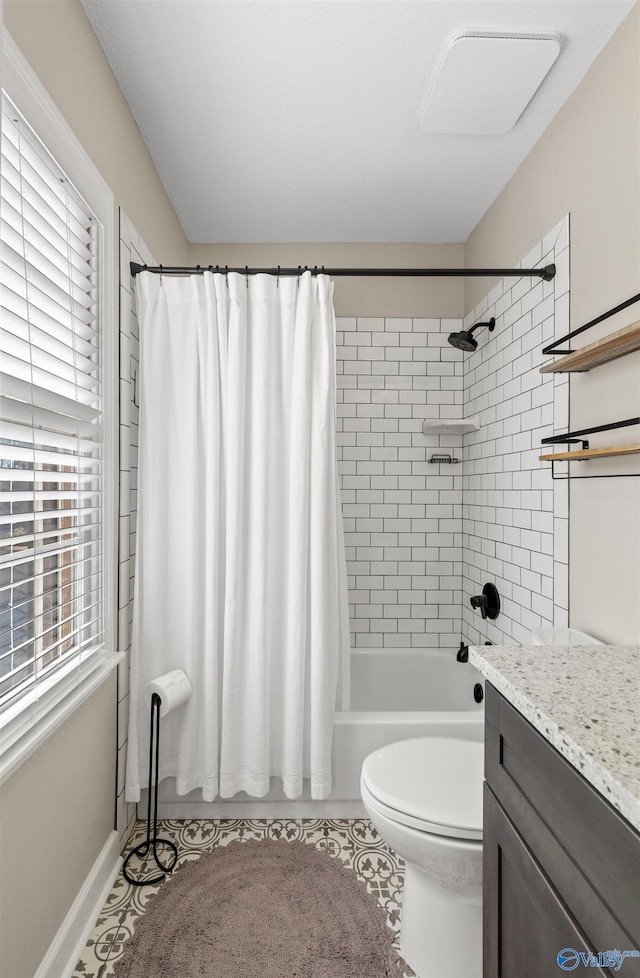 full bathroom featuring tile patterned floors, shower / tub combo with curtain, vanity, and toilet