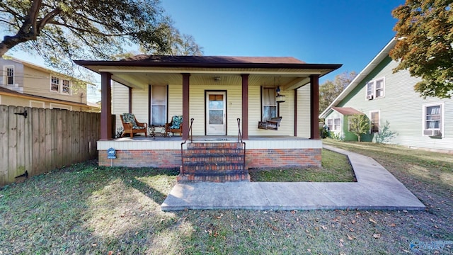 view of front of property featuring a porch and cooling unit