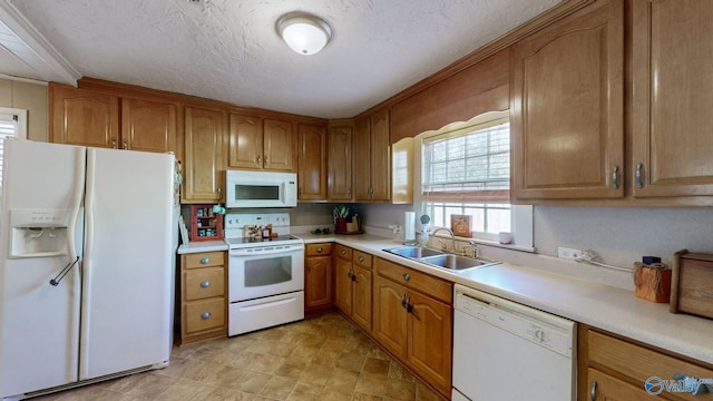 kitchen featuring a textured ceiling, white appliances, crown molding, and sink