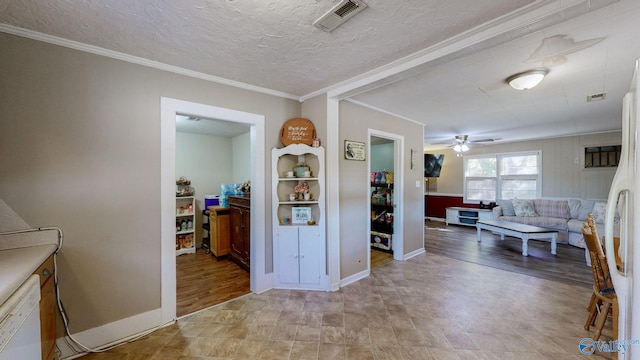 interior space featuring ornamental molding and a textured ceiling