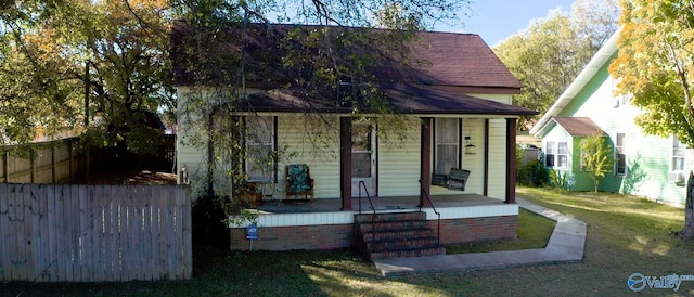 view of front facade with a front yard and a porch