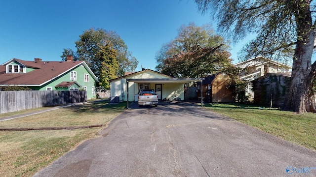 view of front of house featuring a front lawn and a carport