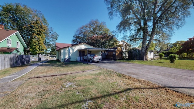 view of front facade with a carport and a front lawn