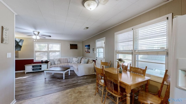 dining area featuring ceiling fan and crown molding