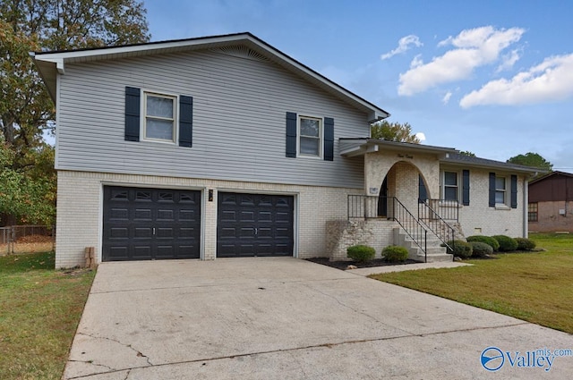 split level home with a front yard and a garage