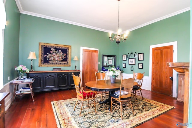 dining space with dark hardwood / wood-style flooring, a notable chandelier, and crown molding