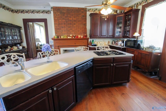 kitchen featuring stainless steel gas stovetop, black dishwasher, light hardwood / wood-style floors, and plenty of natural light