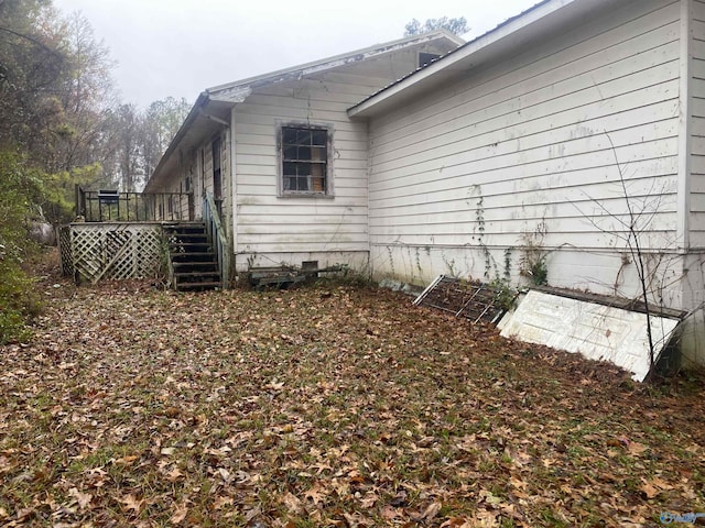 view of home's exterior featuring a wooden deck