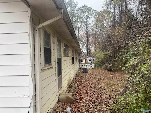 view of side of home with central air condition unit