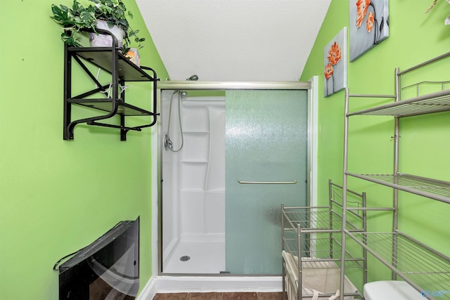 full bath featuring toilet and a stall shower