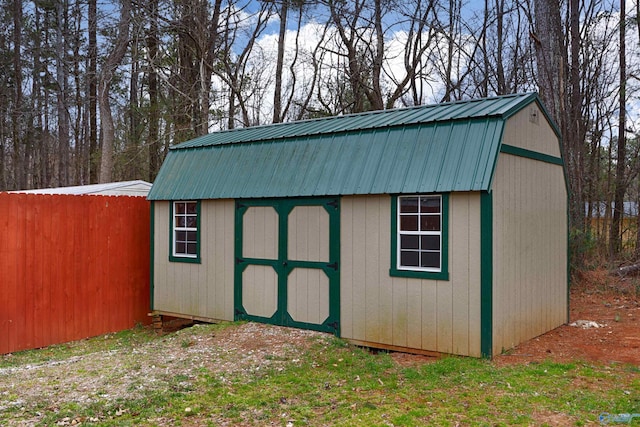 view of shed featuring fence