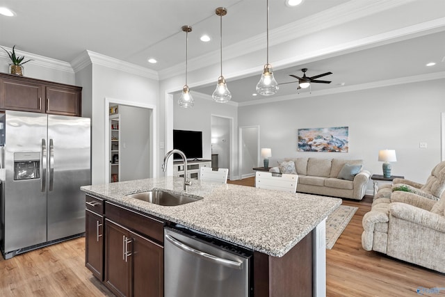 24009 Quints Dr, Athens, AL 35613 - kitchen featuring appliances with stainless steel finishes, a sink, open floor plan, light wood-type flooring, and recessed lighting