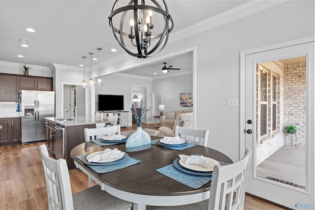 24009 Quints Dr, Athens, AL 35613 - dining room featuring a chandelier, ceiling fan, crown molding, recessed lighting, and light wood-style flooring