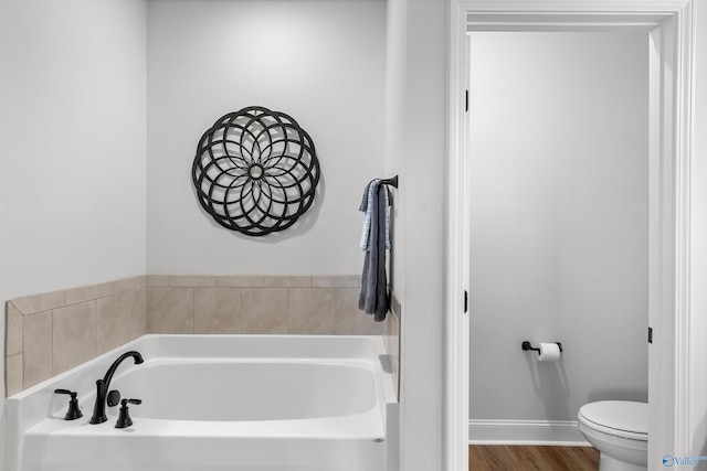 24009 Quints Dr, Athens, AL 35613 - bathroom featuring a bath, toilet, and wood finished floors