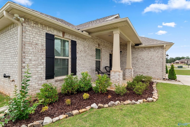 24009 Quints Dr, Athens, AL 35613 - doorway to property featuring a yard, brick siding, a shingled roof, and a porch