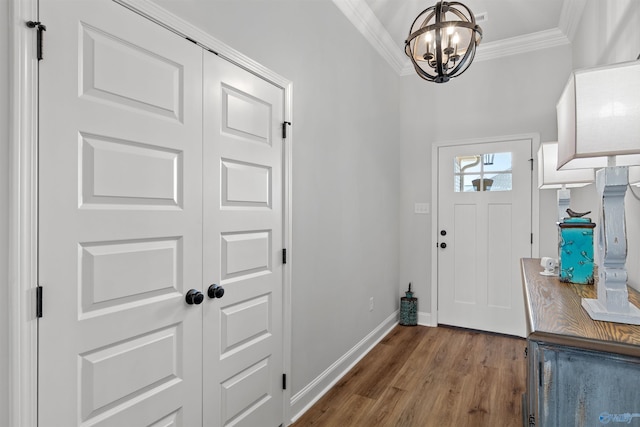 24009 Quints Dr, Athens, AL 35613 - entrance foyer with crown molding, a chandelier, wood finished floors, and baseboards
