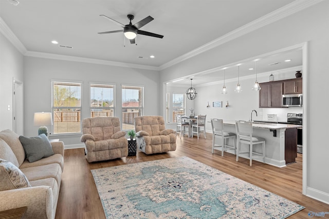 24009 Quints Dr, Athens, AL 35613 - living room with ceiling fan, ornamental molding, wood finished floors, baseboards, and recessed lighting
