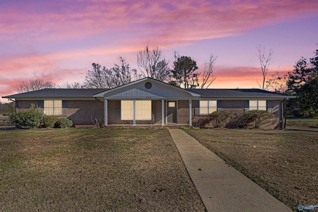 ranch-style home featuring a yard