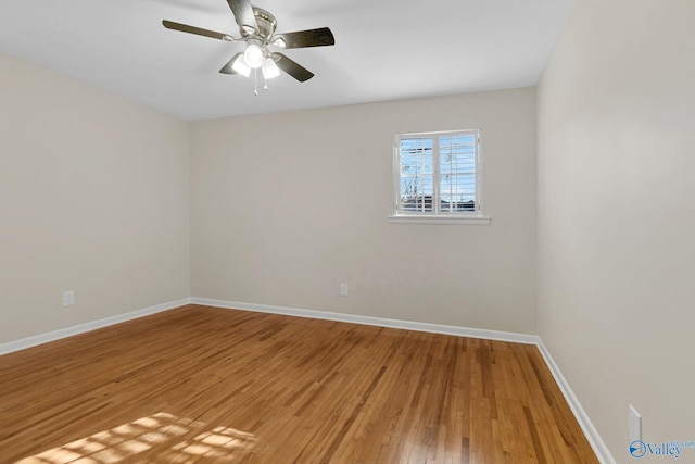 spare room with hardwood / wood-style floors and ceiling fan