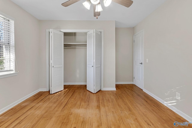 unfurnished bedroom with light hardwood / wood-style floors, a closet, and ceiling fan