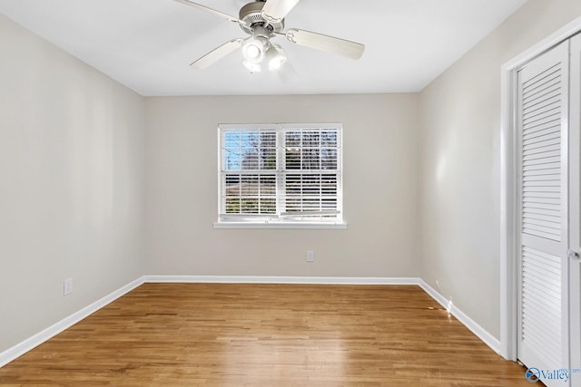 unfurnished bedroom featuring light hardwood / wood-style flooring, ceiling fan, and a closet