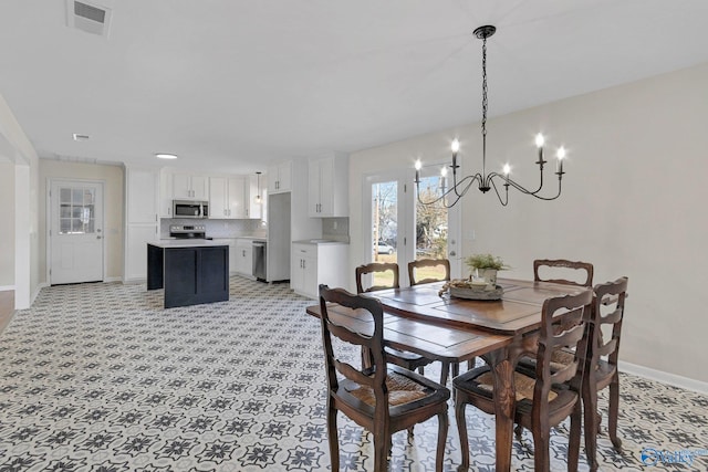 dining space with an inviting chandelier