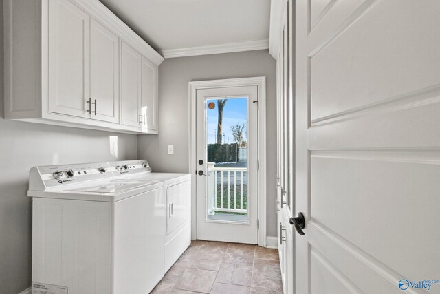 laundry room featuring washer and dryer, cabinet space, and crown molding