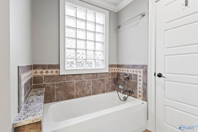 bathroom with crown molding and a bath