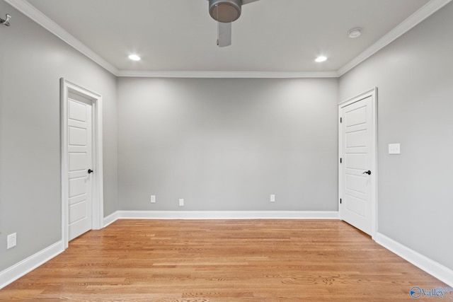 spare room with baseboards, light wood-style flooring, and crown molding