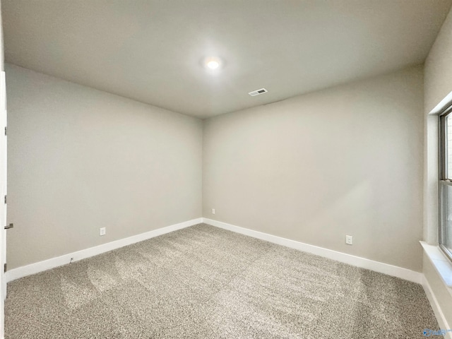 carpeted spare room with a healthy amount of sunlight