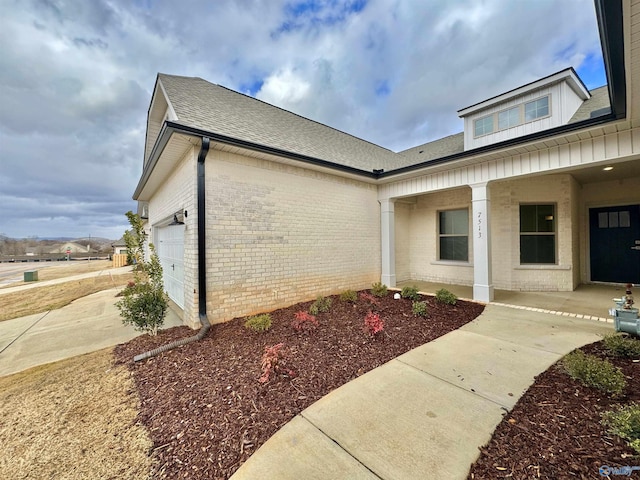 entrance to property featuring a garage and a porch