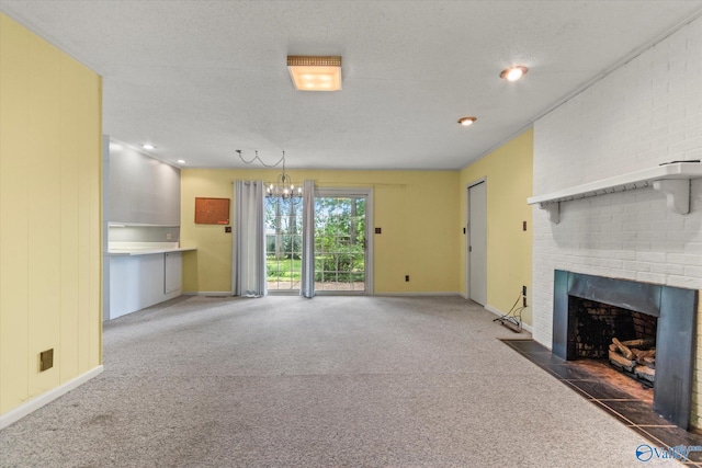 105 Hastings Rd, Athens, AL 35613 - unfurnished living room featuring a brick fireplace, carpet, baseboards, a chandelier, and a textured ceiling