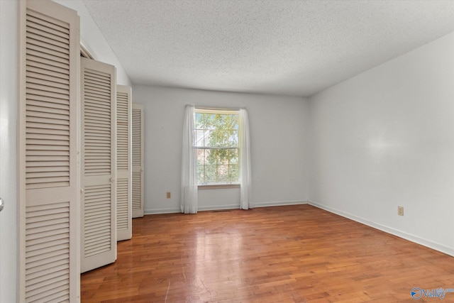 105 Hastings Rd, Athens, AL 35613 - unfurnished bedroom with a textured ceiling, light wood-style floors, and baseboards