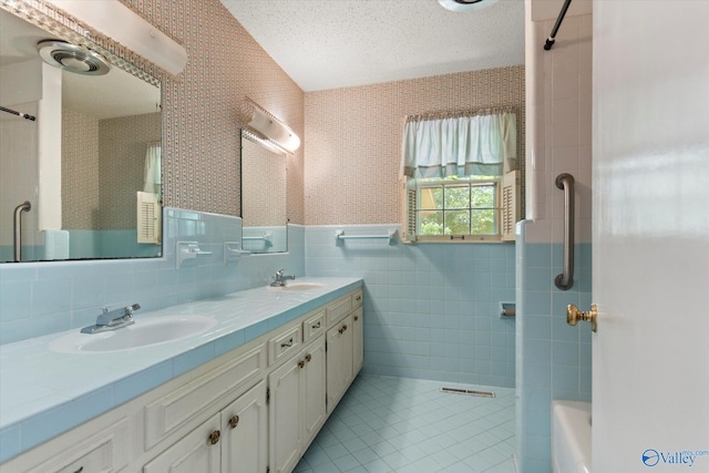105 Hastings Rd, Athens, AL 35613 - full bath featuring tile walls, double vanity, tile patterned floors, a wainscoted wall, and bathing tub / shower combination