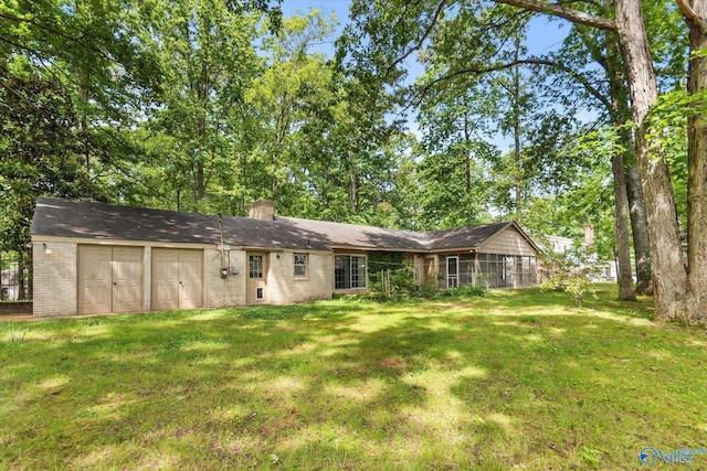 105 Hastings Rd, Athens, AL 35613 - rear view of property with brick siding, a lawn, and an attached garage