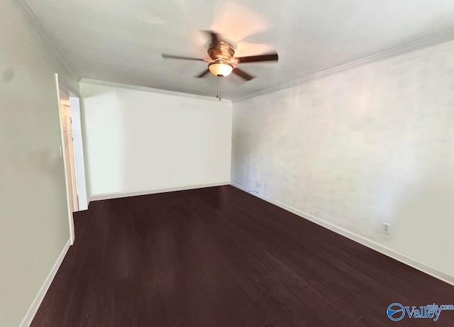 empty room featuring ceiling fan, crown molding, and dark wood-type flooring