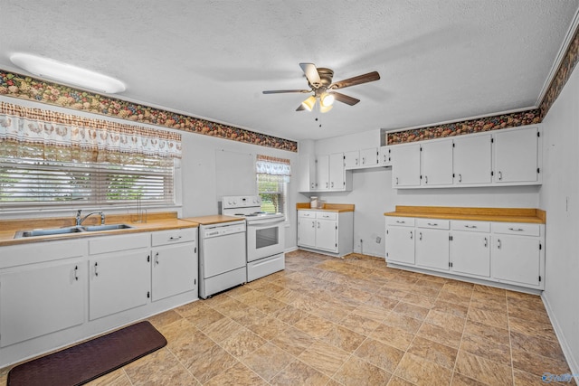 kitchen with a ceiling fan, a sink, white appliances, a textured ceiling, and white cabinetry