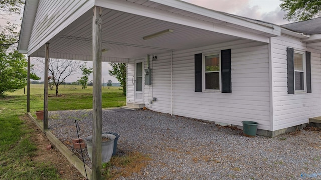view of property exterior featuring a carport and a yard