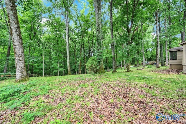 view of yard with a view of trees