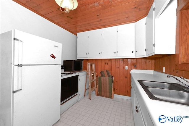 kitchen featuring white appliances, a sink, light countertops, wood ceiling, and white cabinetry