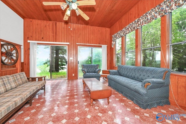 sunroom with ceiling fan, wooden ceiling, and vaulted ceiling