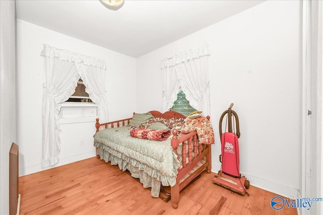 bedroom featuring light wood-type flooring and baseboards