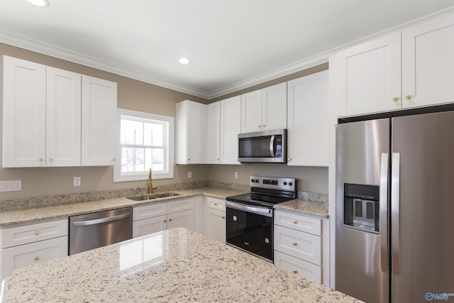 kitchen with a sink, appliances with stainless steel finishes, and white cabinetry