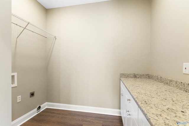 clothes washing area featuring baseboards, dark wood-type flooring, hookup for an electric dryer, and laundry area